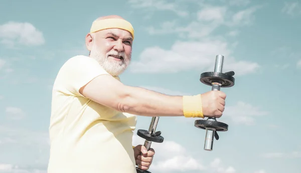 Freedom retirement concept. Grandfather exercising with dumbbell. Sport for senior man. — Stock Photo, Image
