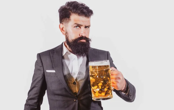 Hipster with beard and mustache in suit drinks beer after working day. Beer time. Handsome barman holding a big cup of beer. — Stock Photo, Image