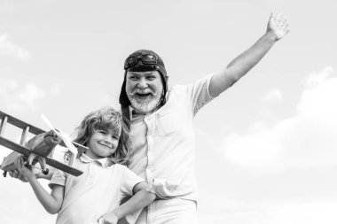 Büyükbaba ve torun oyuncak uçakla oynuyor..