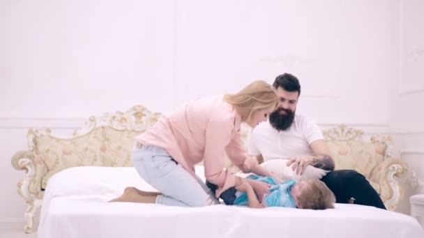 Happy family playing in bedroom. Mother father and child boy play with each other with pillows, happy kid and parents. Happy childhood. — Stock Video