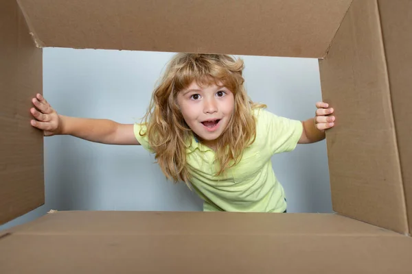 Bambino felice con scatola di cartone, pacco disimballaggio da internet store. Cliente per bambini soddisfatto del servizio di consegna veloce. Concetto di imballaggio o disimballaggio dei pacchi. — Foto Stock