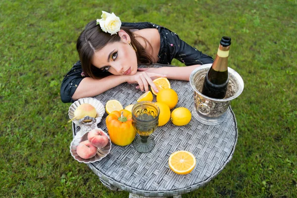 Sexy woman on summer picnic on a grass in the park with wine and fresh fruits. Top above high angle photo vegetarian girl enjoy berries fruits vegetable, dinner table on green grass park outside. — Stock Photo, Image