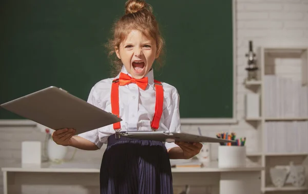 Slecht schoolmeisje versus afstandsonderwijs. Triest kind gebroken online laptop op school. Vernietigende beschadigde computertechnologie. Kinderproblemen met leren op afstand. — Stockfoto