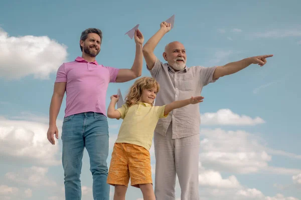 Fathers day. Kid having fun with toy paper plane. Men generation family with three different generations ages grandfather father and son. Weekend family play. — Stock Photo, Image