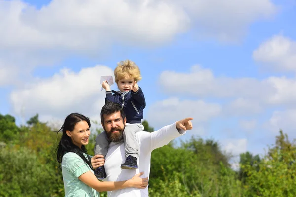 Happy family mother father and child son laughing and havig fun with toy paper plane. Family Weekend. Portrair of cheerful parents and their little child. Children day. — Stock Photo, Image