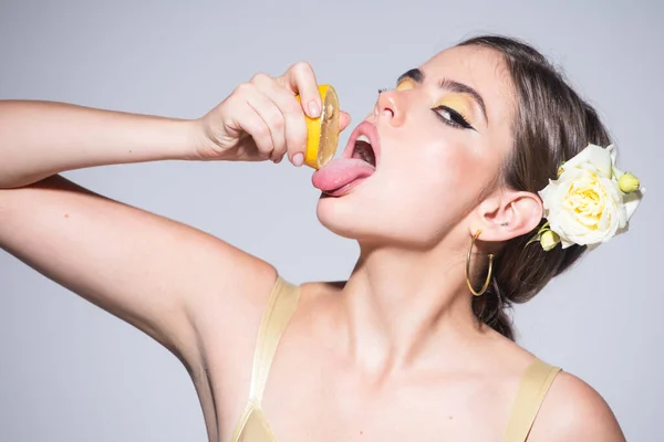 Mooi meisje of sexy vrouw met stijlvolle make-up op mooi gezicht knijpen sap van verse sinaasappel citrusvruchten, likken met tong natuurlijk sinaasappelsap — Stockfoto