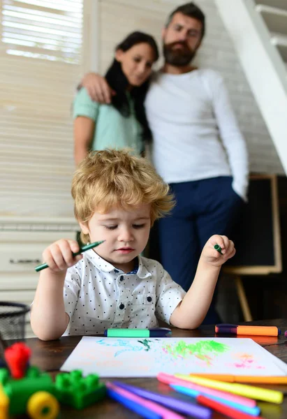 Kid learning painting, little artist painting, drawing. Happy family of three having fun together. Cheerful parents playing with son. Father mother and child drawing together at home. — Stock Photo, Image