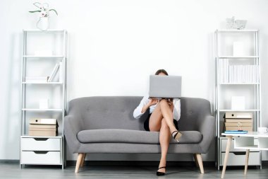 Güzel sekreter bacakları. Baştan çıkarıcı seksi sekreter dizüstü bilgisayarlı ve seksi bacaklı gizli sekreter koltukta oturuyor. Seksi iş kadını. Şehvetli genç kız çalışan..