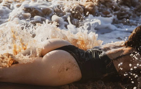 Sexy chica con atractivo botín descansa en la playa. Hermosa mujer con piel bronceada en bikini en la playa cerca del océano. —  Fotos de Stock