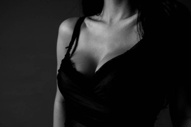 Sexy large breasts. Woman breas, boobs in bra, sensual tits. Beautiful naked body. Lingerie model. Closeup of sexy female boob in black bra.