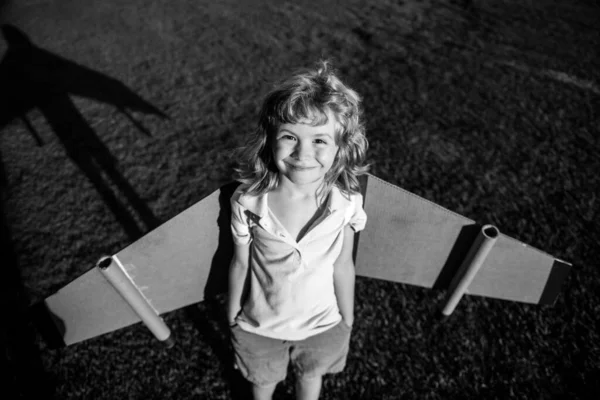 Joli garçon rêveur jouant avec un avion en carton. Enfance. Fantaisie, imagination des enfants. — Photo