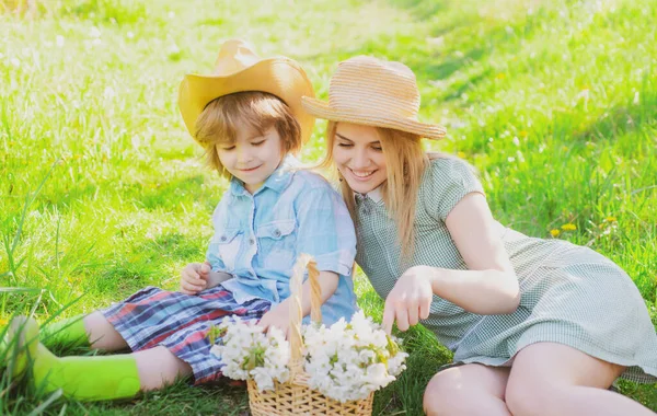피크닉에서 아들 과 함께 행복 한 어머니 날. 공원의 잔디 위에 앉아 있는 아이와 함께 있는 가족 엄마. — 스톡 사진