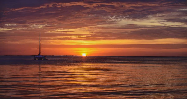 Båt til sjøs ved solnedgang. Seilbåter med seil. Sjøseilas i havet. – stockfoto