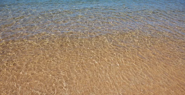 Strand mit goldenem Sand, türkisfarbenem Meerwasser. Panorama-Meerblick. Natürlicher Hintergrund für den Sommerurlaub. — Stockfoto