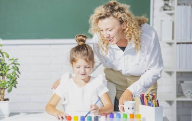Sınıfta genç bir öğrenciyle öğretmen. Anne ve kız öğreniyor..