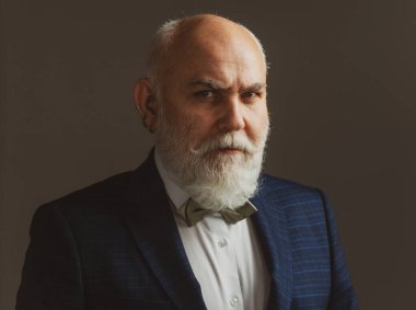 Ciddi kıdemli adam. Sakallı, orta yaşlı, ciddi bir yüz ifadesi olan, yakın plan bir kafa ve omuz portresi olan adam..