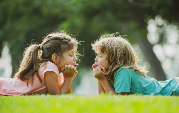 Child couple in love. Children or kids relationships. Little boy girl outdoors in park.