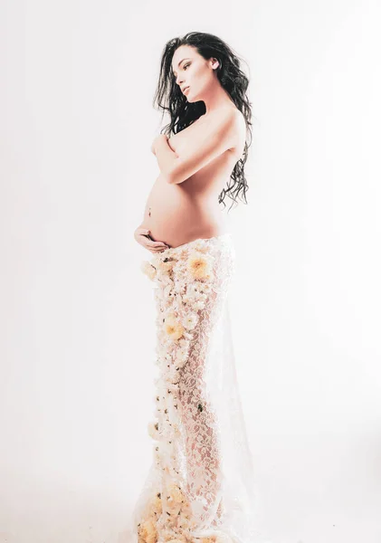 Pregnancy. Maternity preparation. womens health. girl with big belly. future mother have baby inside. life birth expectation. Love. beautiful pregnant woman in spring flower skirt. Waiting for a baby Royalty Free Stock Images