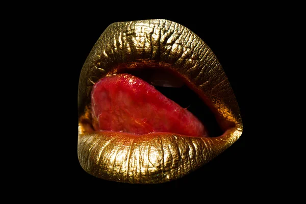 Sensual woman golden lips. Womans natural gold lip. Girl mouth close up with golden lipstick. Tongue licking sexy lips.