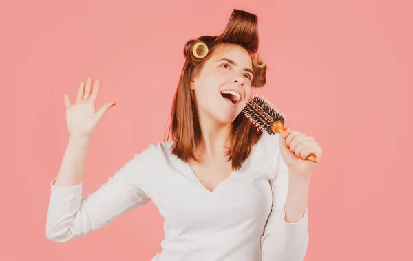 Una mujer divertida cantando con peine. Chica peinando el pelo. Hermosa mujer joven sosteniendo peine alisado cabello. —  Fotos de Stock