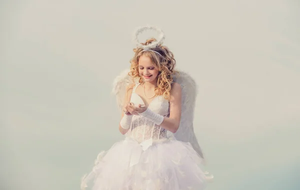 Angel niña con el pelo rubio rizado. Tarjeta de felicitación de arte festivo. Flecha de amor. Encantadora niña rizada en vestido blanco y alas - ángel chica Cupido. — Foto de Stock