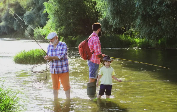 Adoro pescare. Uomo anziano pesca con figlio e nipote. Nonno, padre e figlio pescano a mosca sul fiume. — Foto Stock