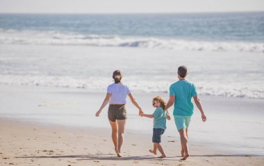 Kumsalda mutlu bir aile. İnsanlar yaz tatilinde eğleniyor. Baba, anne ve çocuk mavi denizde. Dertsiz özgürlük kavramı. Çocuklu aileler Bahamalar 'da rahatlar..