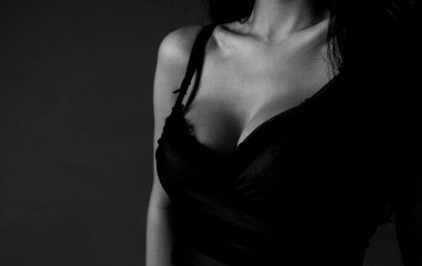 Women with large breasts. Sexy breas, boobs in bra, sensual tits. Beautiful slim female body. Lingerie model. Closeup of sexy female boob in black bra.