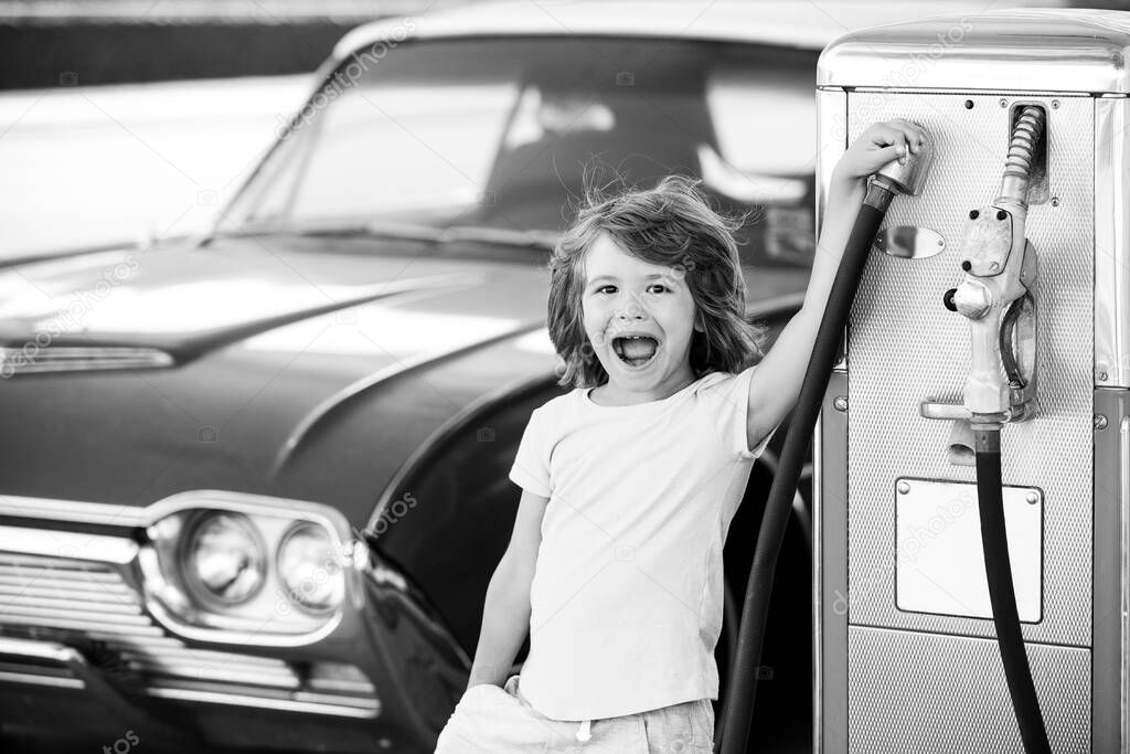 Kid fueling retro car at gas station. Refuel fill up with petrol gasoline. Petrol pump filling fuel nozzle in fuel tank of car at gas station. Petrol industry and service price and oil crisis concept.