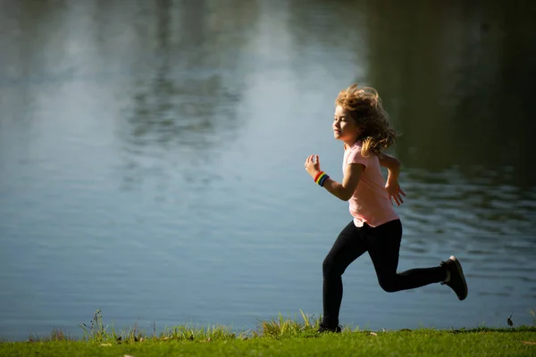 Child boy jogging in park outdoor. Kids sport, happy active kids jogging outdoors, running in spring park. — Stock Photo, Image