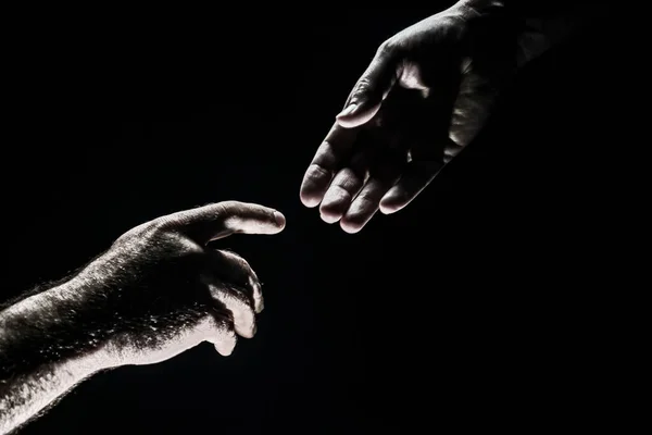 Hombres tomados de las manos aislados en negro. Conexión y relaciones humanas. Rescate manos masculinas. Un apretón de manos amistoso, saludo de amigos, amistad. Rescate, ayuda gesto o manos. Ayudando a la mano. Creación de manos —  Fotos de Stock
