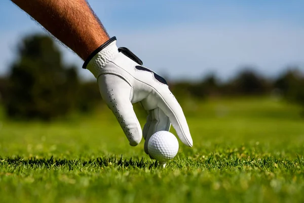 Sostén la pelota de golf. Hombre golfista con guante de golf. Hombre golfista jugando golf en un campo de golf. — Foto de Stock