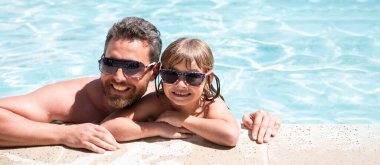Baba oğul havuzda. Tatil konsepti. Yüzme havuzunda mutlu bir aile. Havuz partisi. Babasından bir çocuk. Babalar Günü. Başlık için afiş, kopyalama alanı. Web tasarımı için poster.