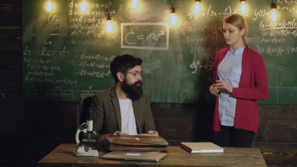 Man and woman in university on blackboard. Teacher in math school explanation math lesson. Professor in a classroom teaching students, Mathematics formula, math science concept. — Stockvideo