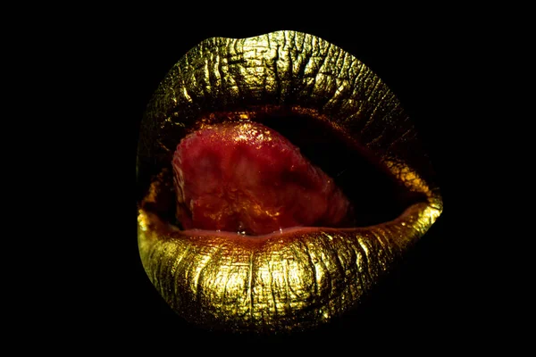 Sensual golden woman lips. Womans gold lip. Female mouth close up with golden lipstick. Woman tongue licking sexy lips. —  Fotos de Stock