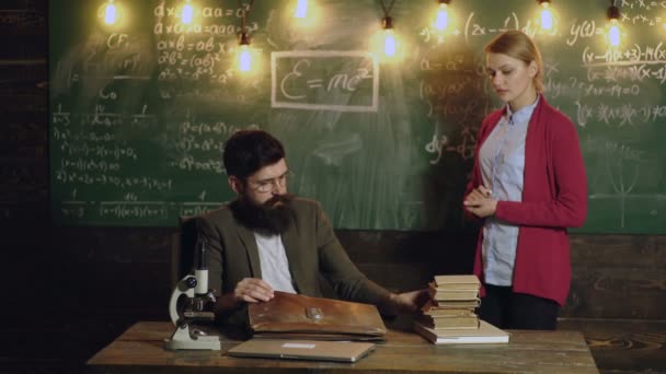 Teacher in math school explanation math lesson. Man and woman in university on blackboard. Professor in a classroom teaching students, education concept. Mathematics lesson. — Video Stock