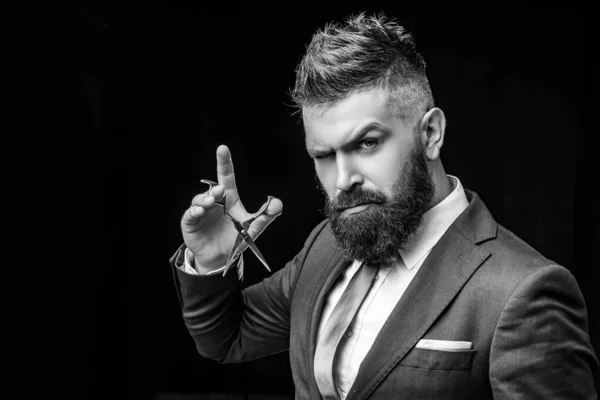 beard care. Mature hipster with beard. bearded man in formal business suit. brutal male hipster cut hair with hairdressing scissors. confident businessman at barbershop. barber and hairdresser salon