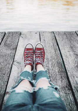 Yalnız emo kırmızı spor ayakkabı içinde oturuyor. Ergenlik sorunları. Rüya ve yalnızlık zaman.