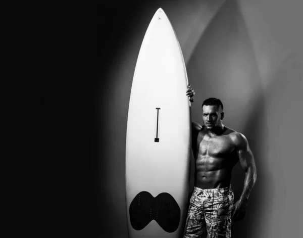 Sexy man met lijfplank. Mannelijke serfer met fit en stevig lichaam. Neon surfplank lichte achtergrond. — Stockfoto