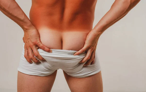 Mans ass tan. Males underwear. Panties down. Mens naked butt. Metrosexual concept. Sexy man buttocks. — Stock fotografie