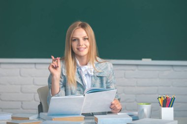 Okulda ya da üniversitede elinde kitap dersi tutan kız öğrencinin portresi.