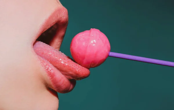 Licking tongue lips. Lips with candy, sexy sweet dreams. Female mouth licks chupa chups, sucks lollipop. — Foto de Stock