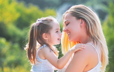 Çocuk sevgisi. Mutlu aile ve güzel anne-kız birlikte vakit geçiriyorlar. Anneler Günü. Anneler Günü. Anne ve kızı kameraya bakıp eğleniyor..