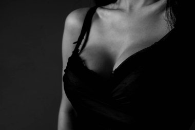 Lingerie model. Women breasts. Sexy breas, boobs in bra, sensual tits. Beautiful nude female body. Closeup of sexy girl boob in black bra.