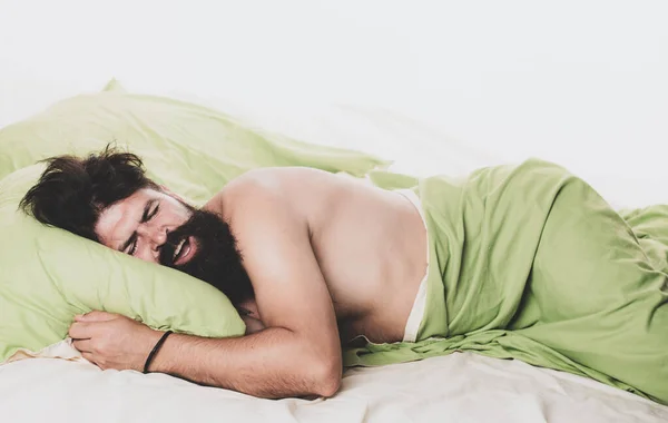 Young man sleeping on soft pillows in bed at home. Napping man concept. Man sleeping on pillow in bed at home. — Stock Photo, Image
