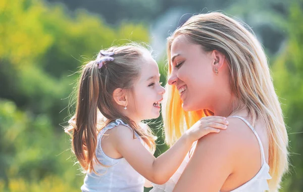 Child love. Happy family and lovely mom and daughter spend time together - mothers day. Mothers day. Mother and daughter enjoy and looking at the camera. — Stock Photo, Image