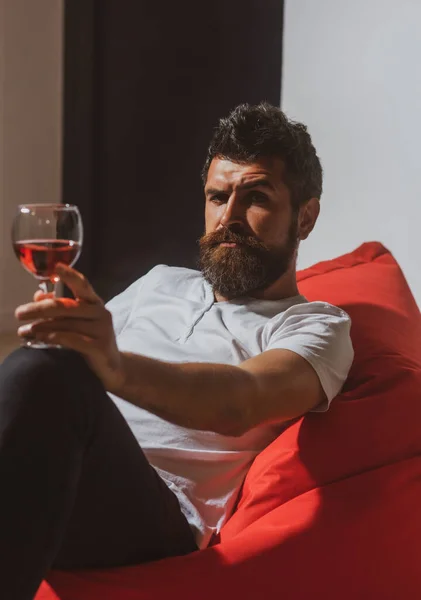 Celebrate alone. Hipster with alcohol. Bearded man with wine. Home alone party.