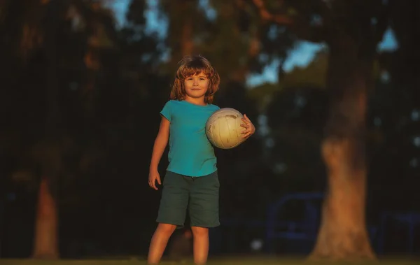 Niños de fútbol, niños juegan al fútbol al aire libre. Chico joven con pelota de fútbol haciendo patada. Jugadores de fútbol. Juegos de pelota activa. —  Fotos de Stock