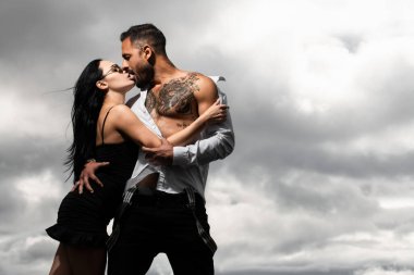 Beautiful naked couple of lovers kissing. Beautiful woman and sexy man boyfriend. Man embracing and going to kiss sensual woman.