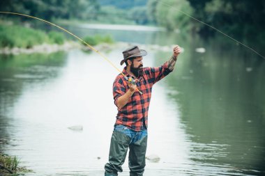 Man with fishing rod, fisherman men in river water outdoor. Summer fishing hobby.